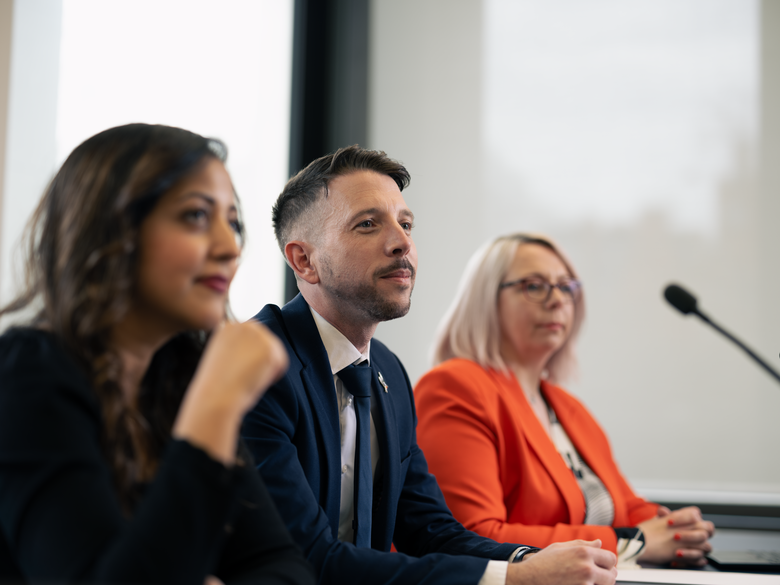 Three magistrates sitting in court on a bench. One Asian female, one white male and one white female