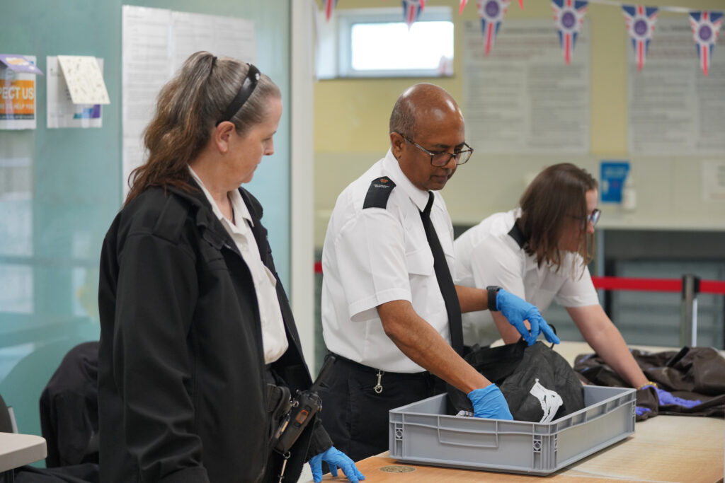Three operational support grades search bags with medical gloves on
