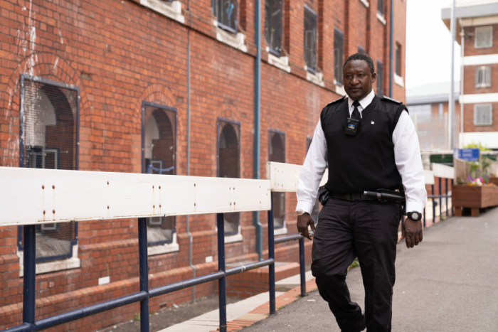 Prison officer walking around the prison grounds.