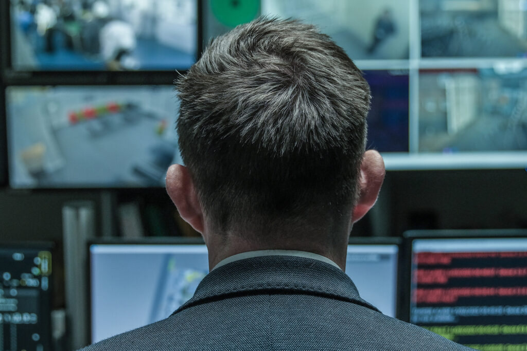 A male leader in a prison control room