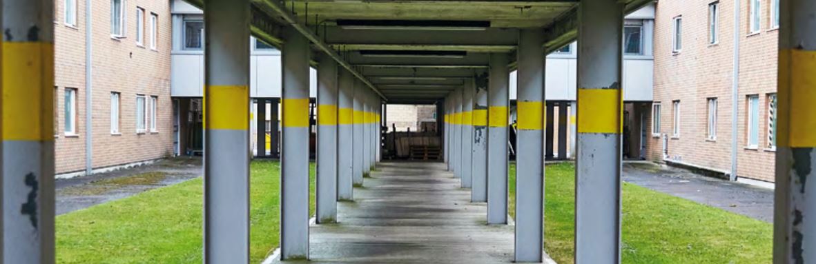 Photograph of an external corridor area in a prison.