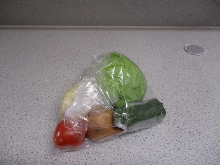Photograph of a Kosher meal pack at HMP Five Wells. It is a selection of vegetables wrapped in cellophane.