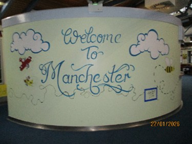 Photograph of 'Welcome to Manchester' wall art.