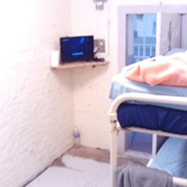 Photograph showing damaged flooring in a cell during the inspection in 2025.