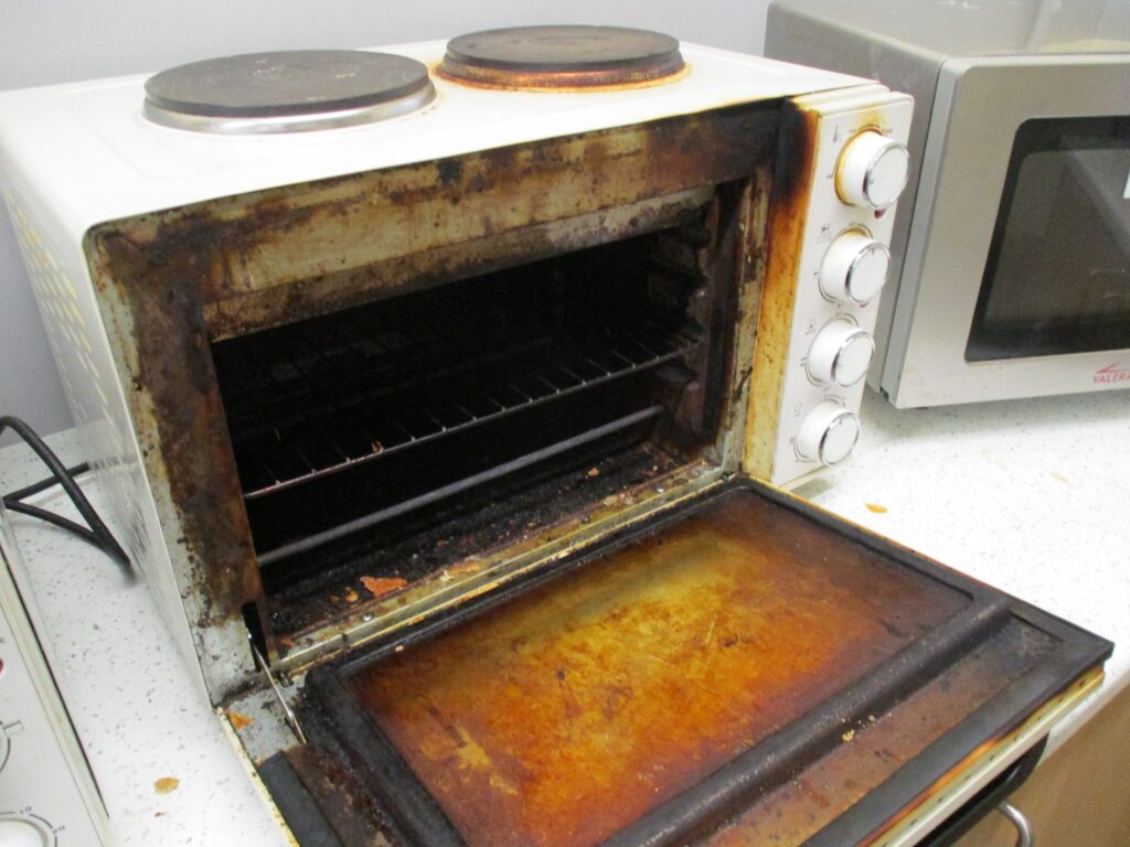 Photograph of a dirty grill on a residential unit.