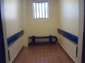 Photograph of the same B wing storage cupboard after permanent repair work had been completed; the wood is no longer visible and instead the wall has been plastered and re-painted.