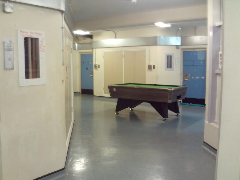 Photograph of the Compass Unit, showing a small communal space in which a pool table can be seen.