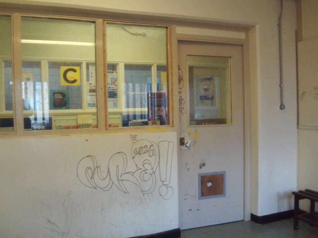 Photograph of the healthcare waiting room. Graffiti can be seen on the wall.