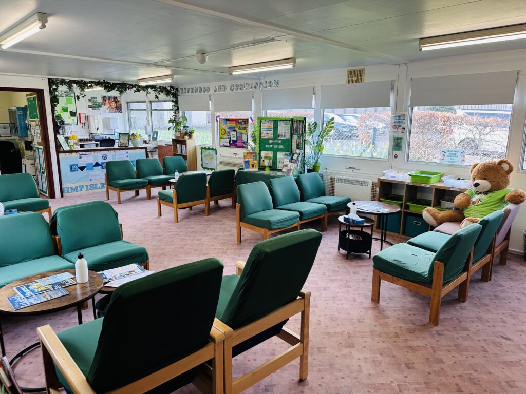 Photograph of the interior of the visitors centre, with easy chairs arranged around coffee tables.  The furniture is arranged either side of a corridor that runs down the middle of the room.