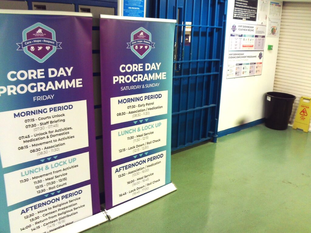 Photograph of two pop-up banners with the details of the new core day regime printed on them, displayed on the wings.