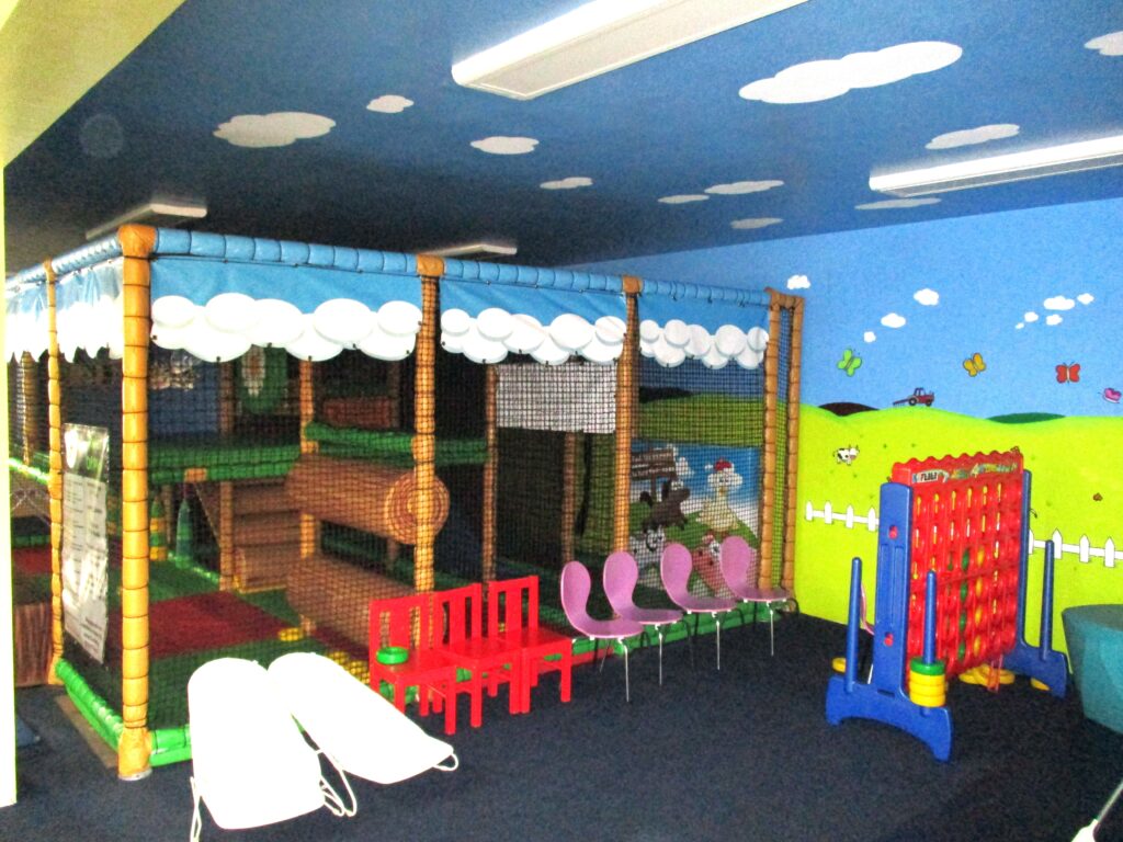 Photograph of the children's play areain the visits hall, with toys ready to be played with.