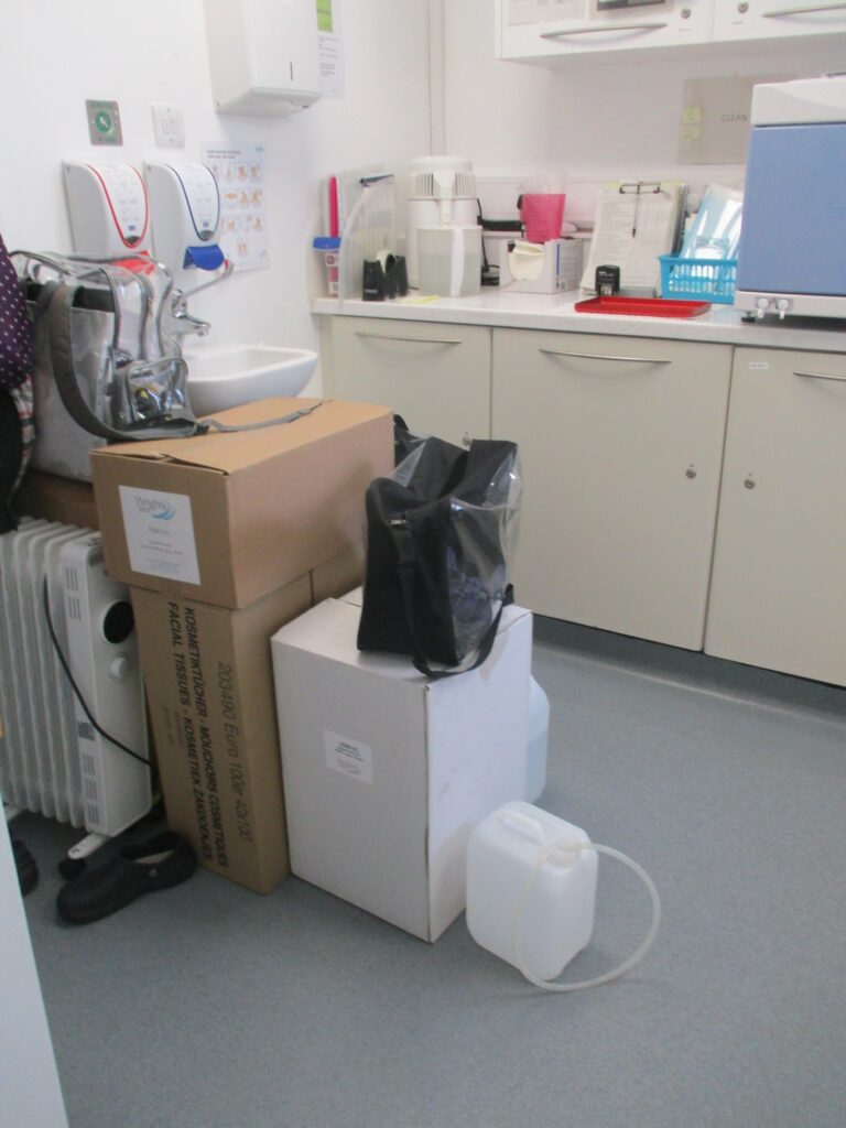 Photograph of the dental suite with items cluttering up the space.