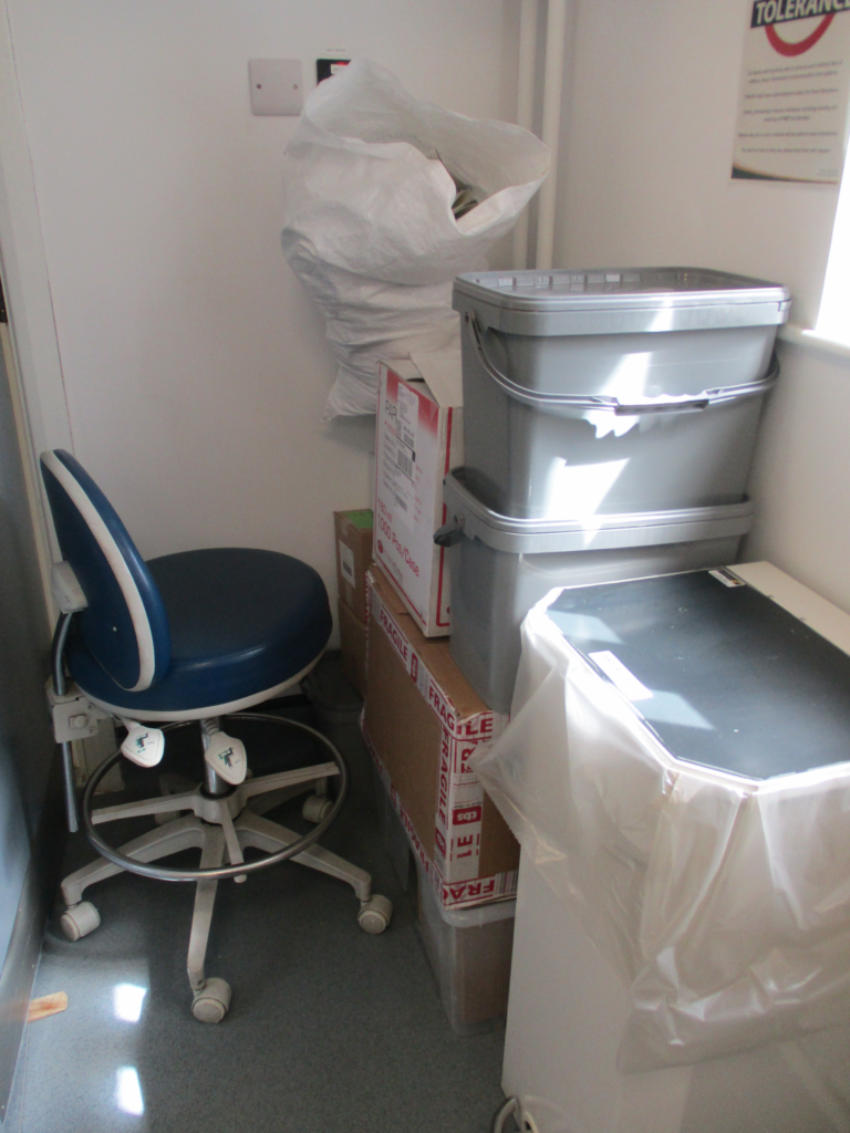 A second photograph of the dental suite, again with lots of items cluttering up the space.