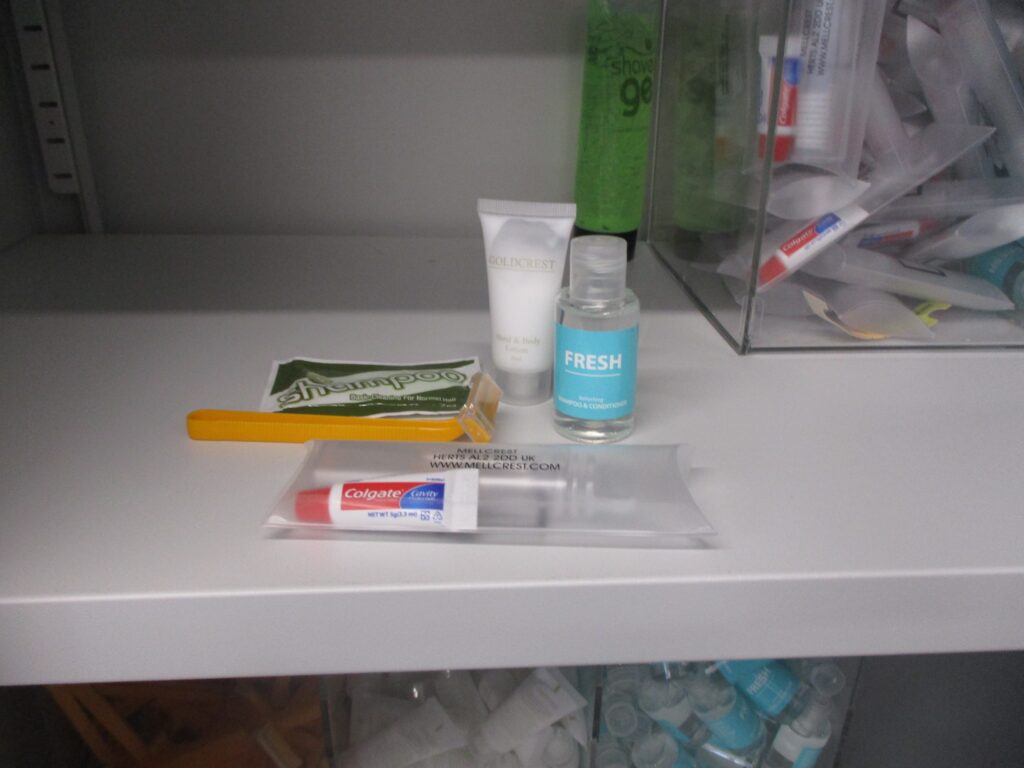 Photograph of a pack of toiletries given to leavers in the resettlement hub. It contains items including shower gel and toothpaste.