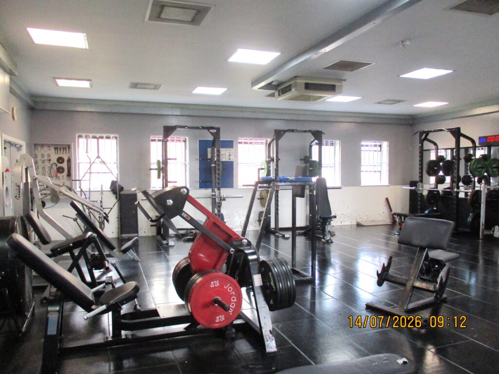 Photograph of the weights room in the gym on the north site. A variety of exercise machines are visible.