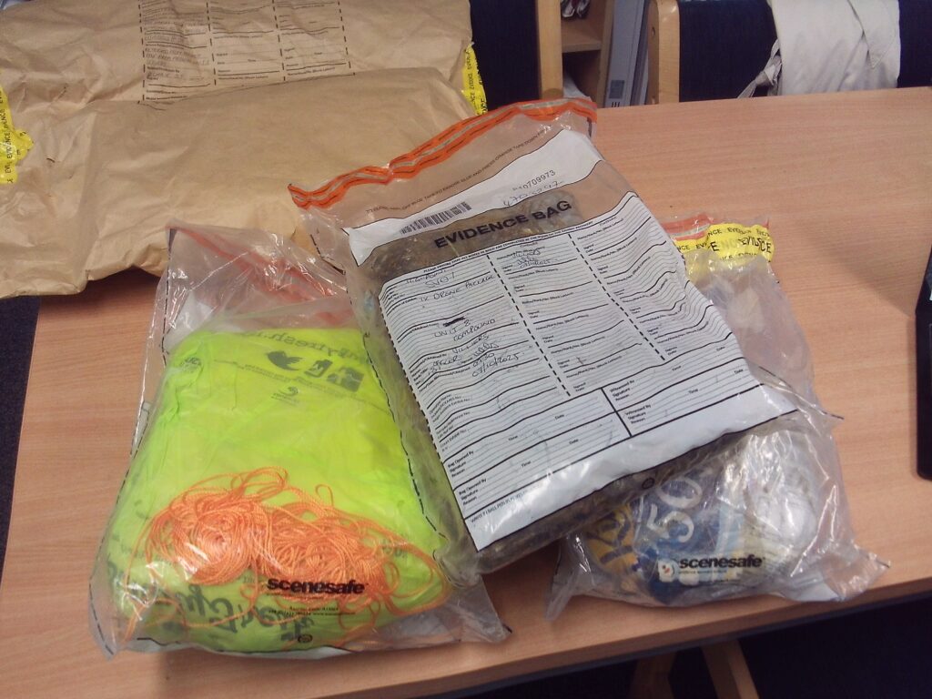 A photograph of three plastic bags with intercepted drone packages in them.