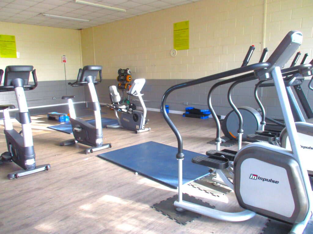 A photograph of the interior of the fitness suite, with rows of cardiovascular exercise machines.