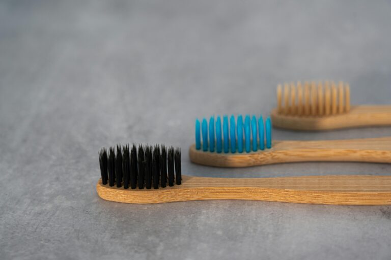 Three toothbrushes laid on a surface