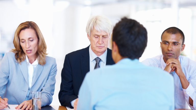 An interview panel facing an interviewee