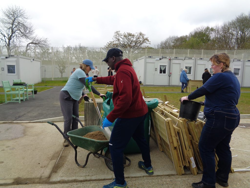 A group of volunteers gardening at HMP Send