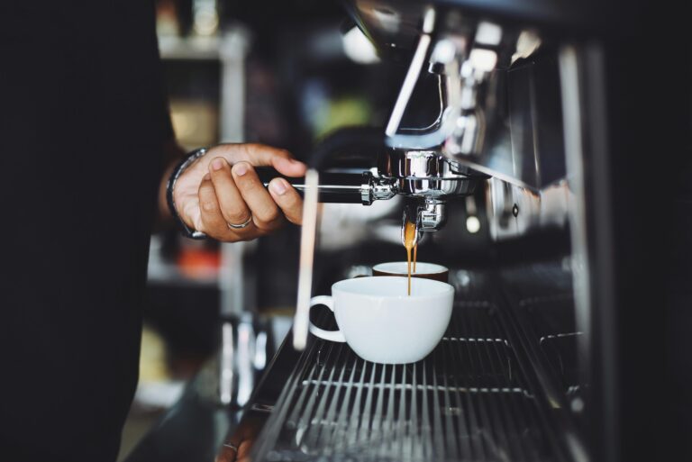Stock image of a barista operating a café coffee machine