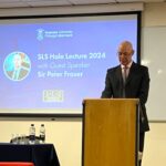 Photo of Sir Peter Fraser on a podium, addressing the audience.