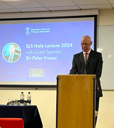 Photo of Sir Peter Fraser on a podium, addressing the audience.