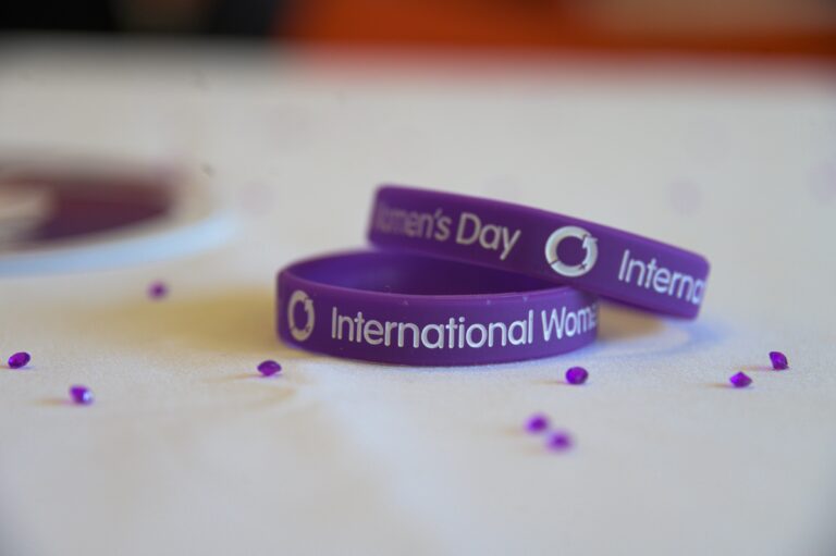 Image of two bracelets showing the International Women's Day logo.