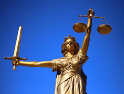 Image of the Lady Justice with a blue sky background