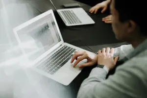 Image of a person using a silver laptop